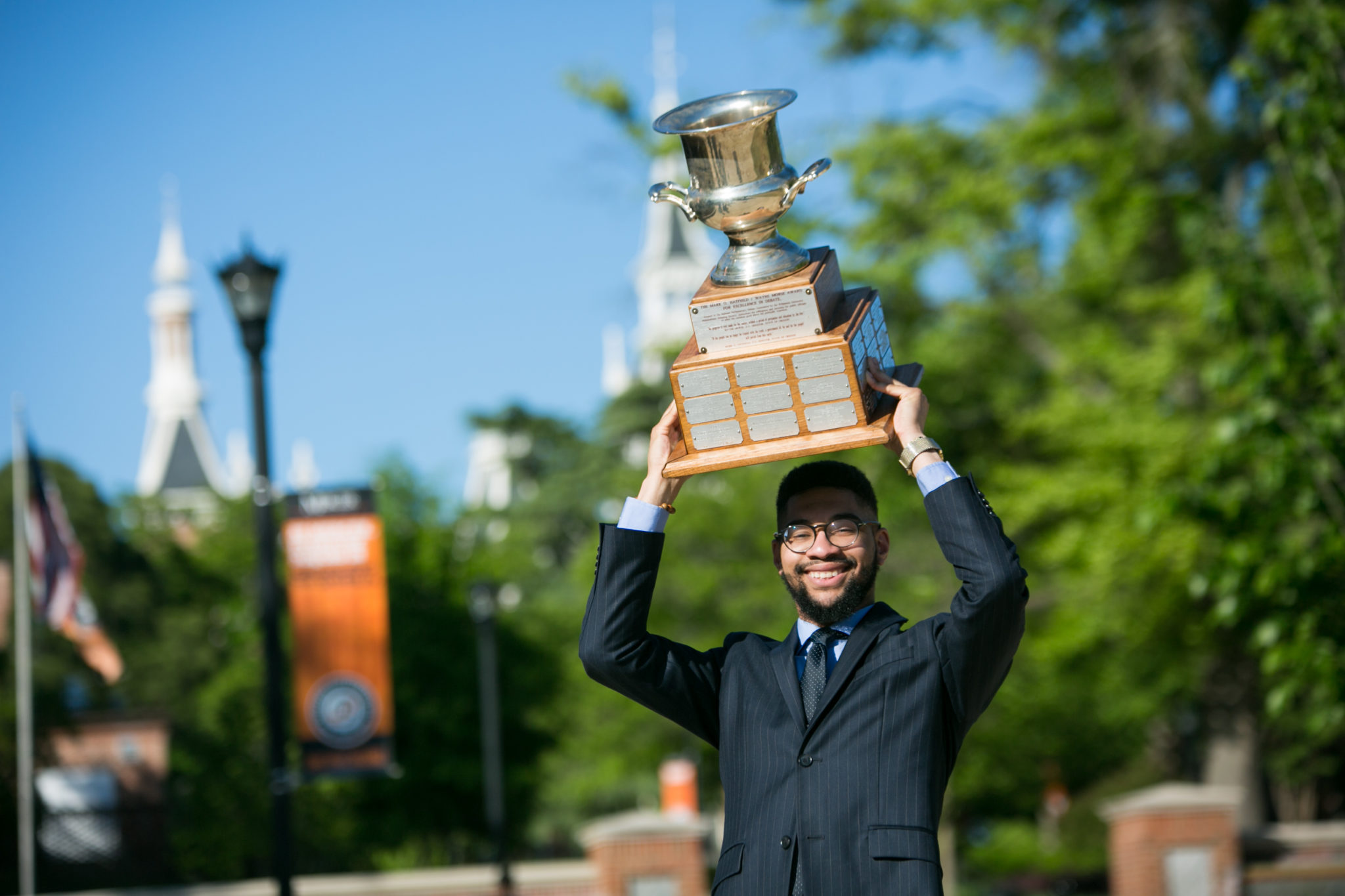 Student holding up trophy