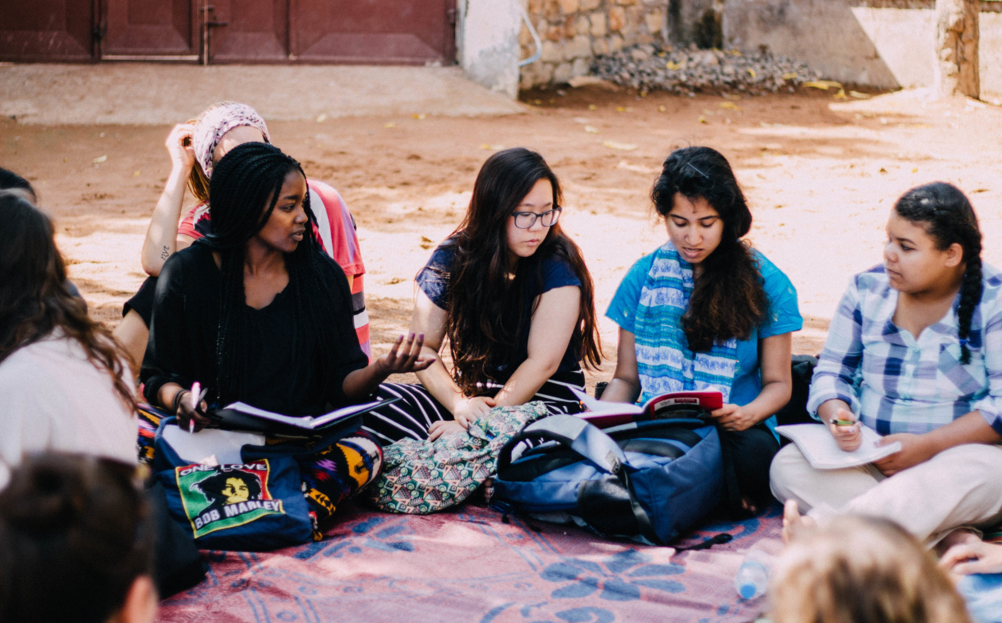 Students sit in a circle in Tanzania.