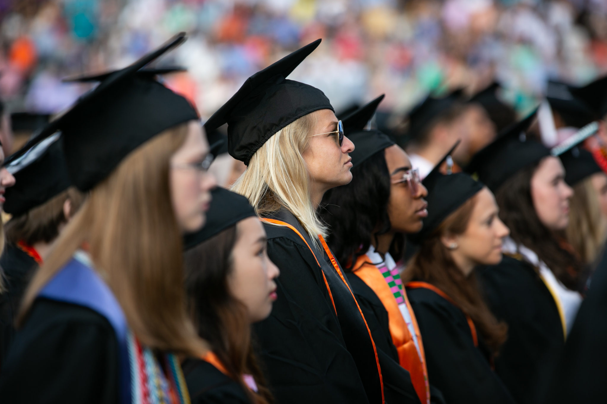 Students wearing caps and gowns at commencement