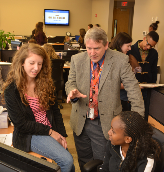 Journalism students and a professor in The Telegraph newsroom