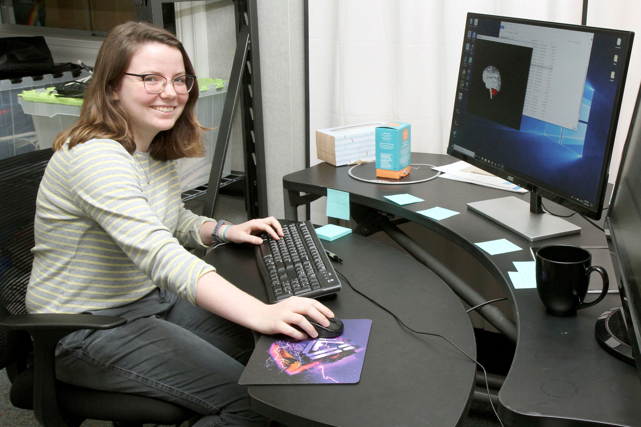 A Neuroscience student sits at a computer modeling a brain