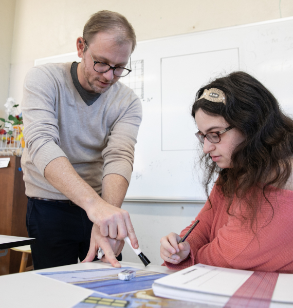 A professor works with a student