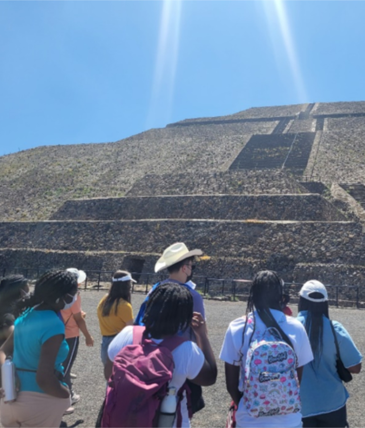 a group of students gaze at the pyramids of teotihuacan