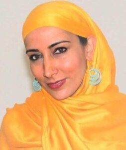 headshot of woman wearing yellow headscarf