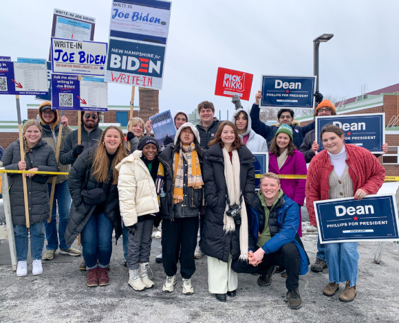 Mercer students holding political signs for Nikki Haley, Dean Phillips, and to write-in Biden.