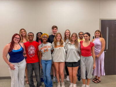 Twelve mentors pose for a photo.