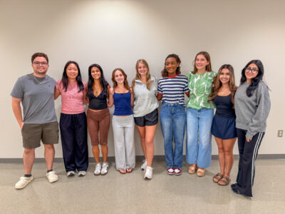 Nine mentors pose for a photo.