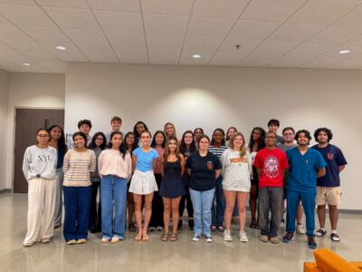Twenty-five mentors pose for a photo.
