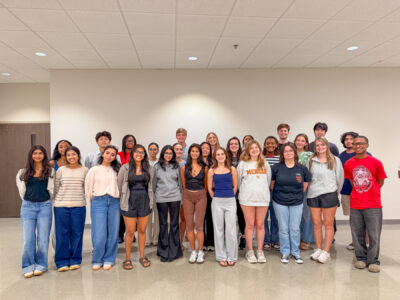 Twenty-six mentors pose for a photo