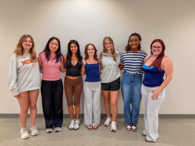 Seven mentors pose for a photo.
